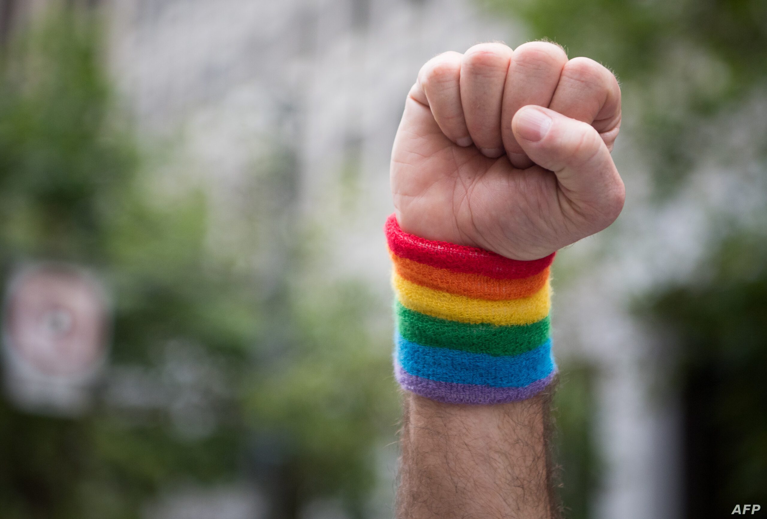 A man raises a fist while marching along the parade route during the San Francisco Pride parade in San Francisco, California on Sunday, June, 25, 2017. / AFP PHOTO / Josh Edelson